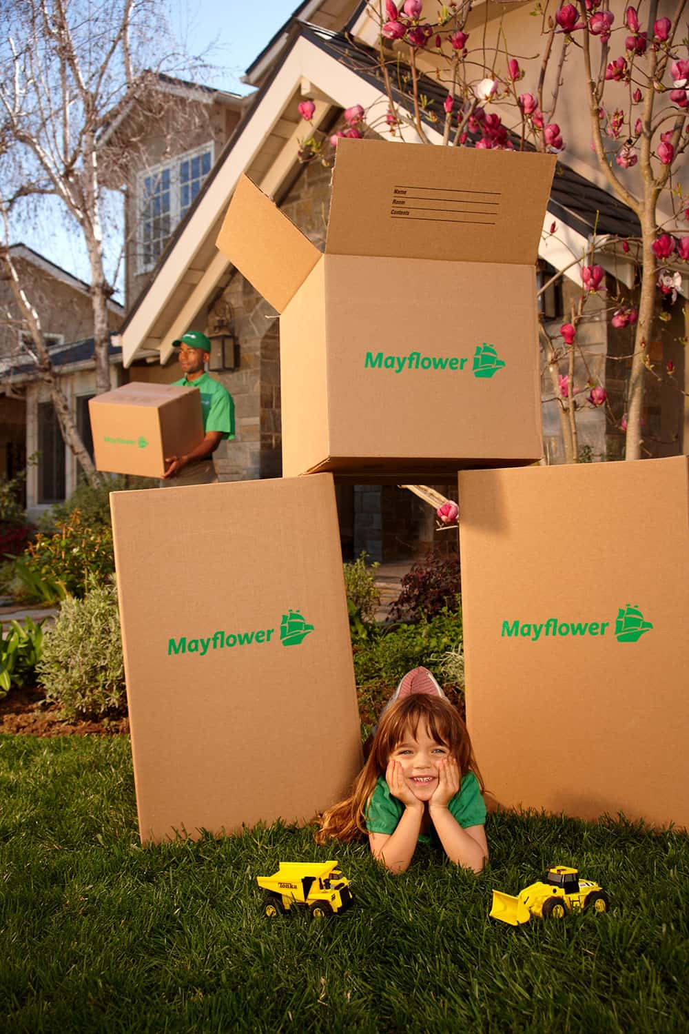 child paying with moving boxes